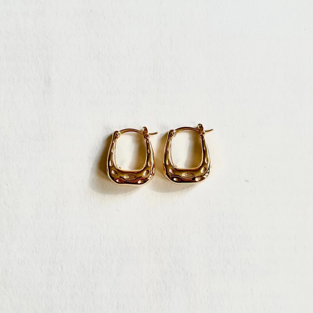 Textured gold square hoop earrings on white background