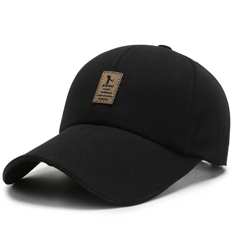 Black baseball cap with curved brim and brown patch logo on the front
