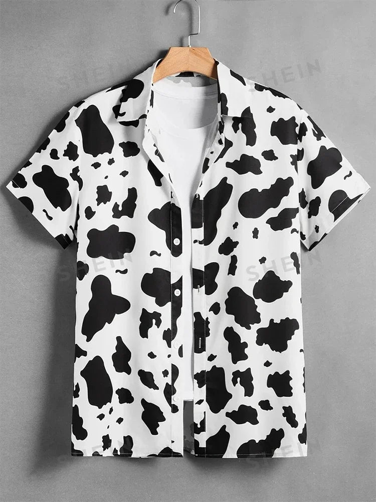 Short sleeve button-up shirt with black and white cow print pattern on hanger