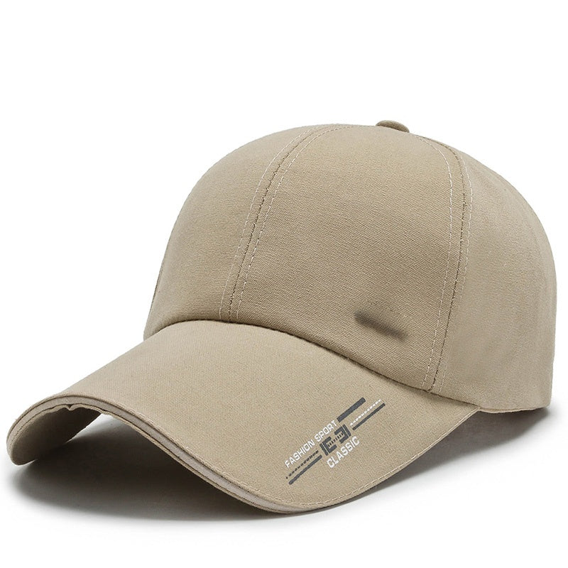 Beige baseball cap with curved brim and stitched sporty classic logo on the side
