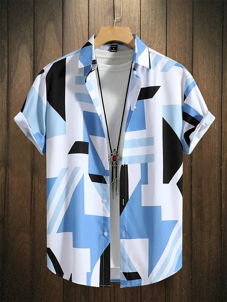 Men's short sleeve button-up shirt with blue and black abstract geometric print, layered over a white t-shirt on a wooden hanger.