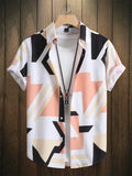 Men's short sleeve button-up shirt with geometric beige, peach, and black pattern on hanger