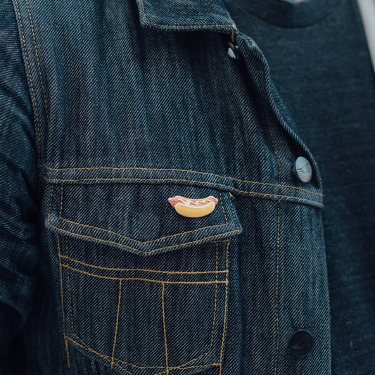 hotdog pin on a denim jacket